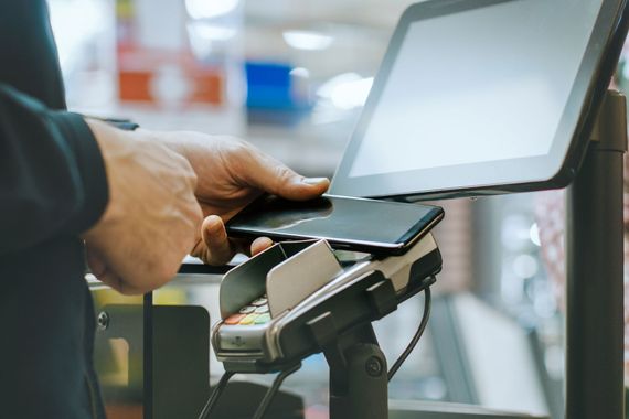 Jörg Flohr Wägetechnik, In the Supermarket Close-up Footage of the Man Paying with Smartphone at the Checkout Counter. 